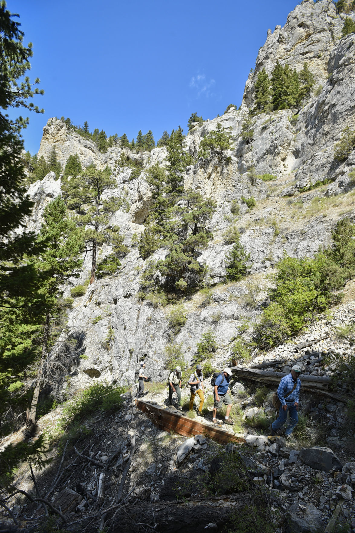 Forest Service officals and members of the press hike in to Mann Gulch
